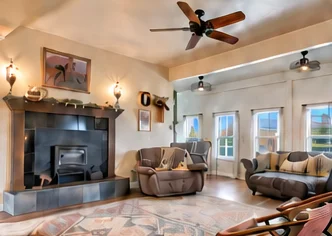 Living room with wood stove and ceiling fan